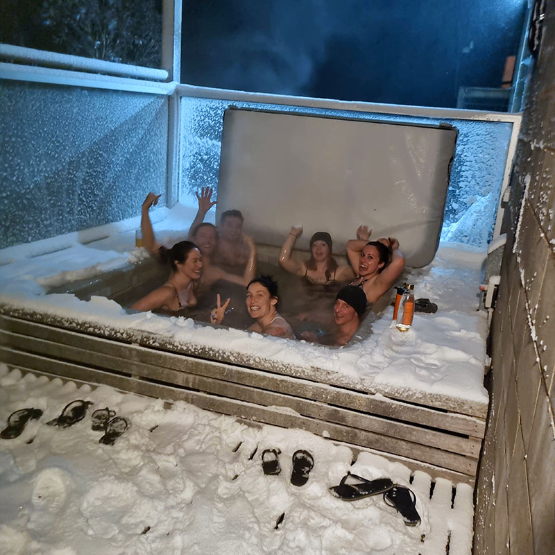 People in spa pool in snowy landscape